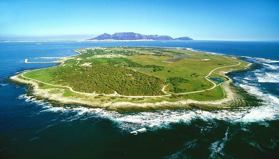 Robben Island from the air, with Table Mountain on the horizon.