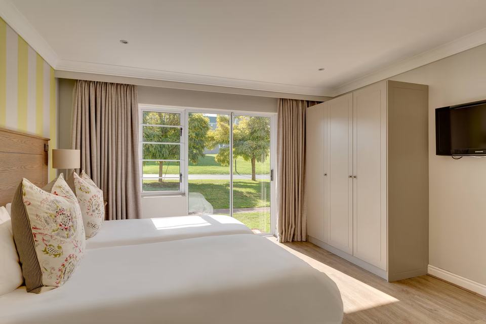 A bedroom with doors onto the garden.